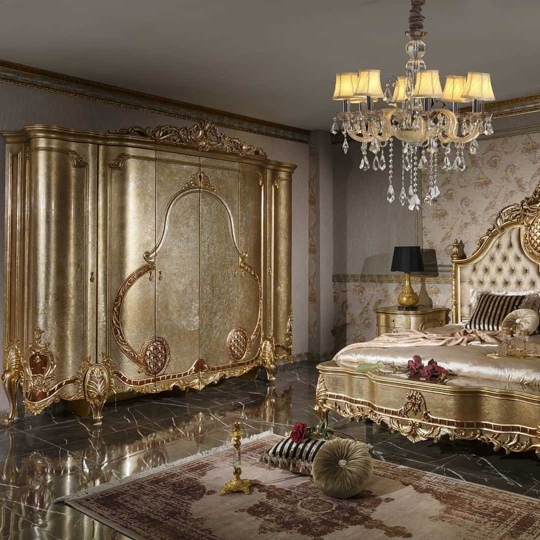 Champagne gold royal bed and carved wardrobe in a luxury bedroom