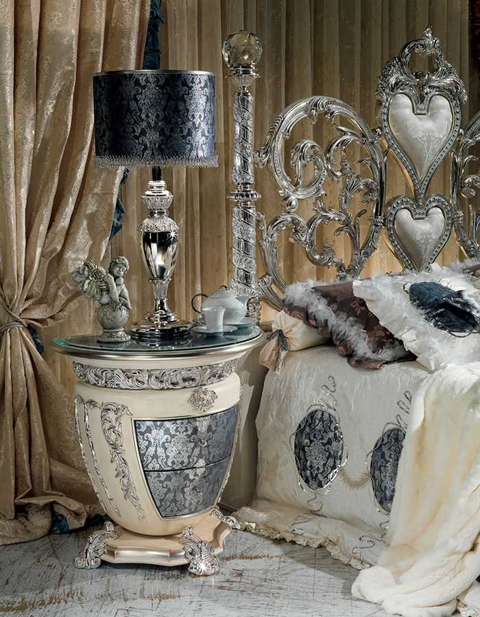 Grand Luxury Silver Bedroom Set with Scroll Work Heart Headboard, Crystal Top Posts, Ornamental Side Tables And Decorative Baroque Mirror